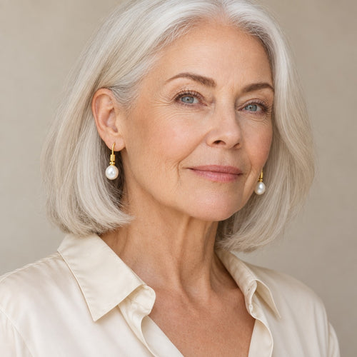 Woman in her fifties wearing the Adriana ribbed hook pearl earrings, hair pulled back