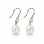Adriana pearl earrings, 7-8mm white rice pearls beneath ribbed shepherd's hooks and caps - second finish