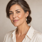 Woman in her thirties wearing the Alba pearl hook earrings, hair down