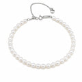 Alexandra classic single-strand white freshwater pearl bracelet with silver clasp and heart charm, flat lay on beige