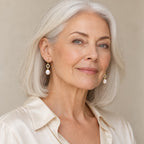 Woman in her forties wearing the Antonia pavé ring pearl hook earrings, hair tucked behind her ear