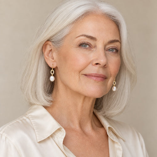 Woman in her forties wearing the Antonia pavé ring pearl hook earrings, hair tucked behind her ear