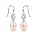 Antonia pearl earrings, 7-8mm white rice pearls hanging from small pavé rings on shepherd's hooks - second finish