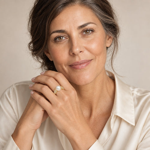 Close-up of a model's hand wearing the Ayla pavé shoulder pearl ring in gold