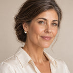 Woman in her forties wearing the Benedetta open teardrop pearl studs, hair up