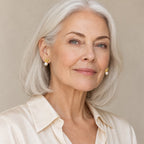 Woman in her forties wearing the Cassandra rabbit ear pearl studs, hair pinned up