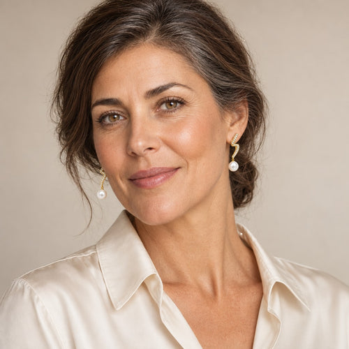 Woman in her thirties wearing the Celine zigzag pearl drop earrings, hair down