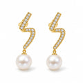 Celine pearl earrings, 7-8mm white button pearls hanging from pavé zigzag bars