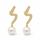 Celine pearl earrings, 7-8mm white button pearls hanging from pavé zigzag bars