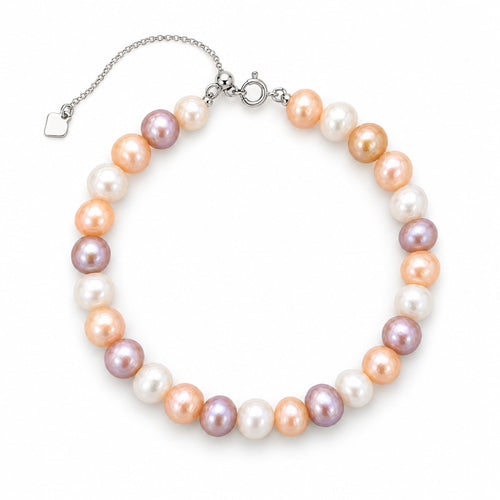 Chiara multicolor freshwater pearl bracelet with silver slider chain and square tag charm, flat lay on light gray