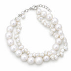 Clara double-strand white freshwater pearl bracelet with a round strand and a keshi strand on a blue resin slab