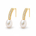 Clemence pearl earrings, 7-8mm white rice pearls fixed beneath curved pavé bars