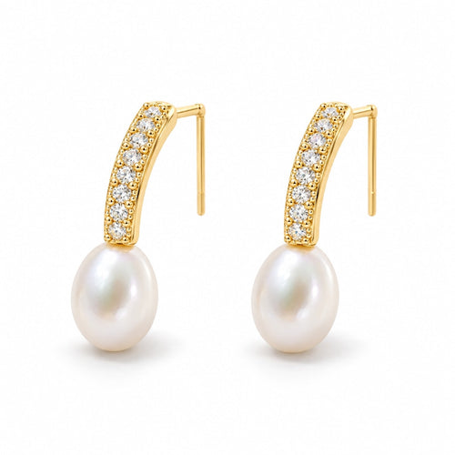 Clemence pearl earrings, 7-8mm white rice pearls fixed beneath curved pavé bars