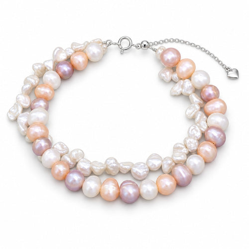 Cosima double-strand bracelet with multicolor potato pearls and white keshi pearls, flat lay on light blue