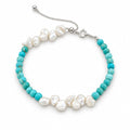 Federica turquoise-blue bead bracelet with two clusters of white keshi pearls, flat lay on white
