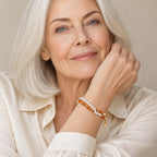 Close-up of a wrist wearing the Francesca pearl and orange bamboo bead double-strand bracelet