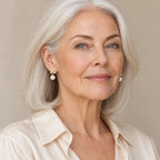 Woman in her forties wearing the Gabrielle crystal flower pearl earrings, hair down