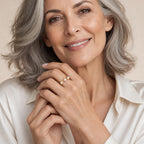 Close-up of a model's hand wearing the Ida triple pearl crown ring in gold