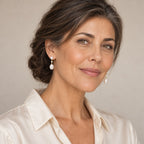 Woman in her thirties wearing the Ines two-pearl drop earrings, hair down