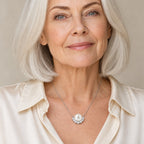 Woman wearing the Joan pavé arc pearl pendant necklace at the collarbone over a black ribbed top