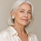 Woman in her fifties wearing the Lieke camellia pearl stud earrings, hair swept up