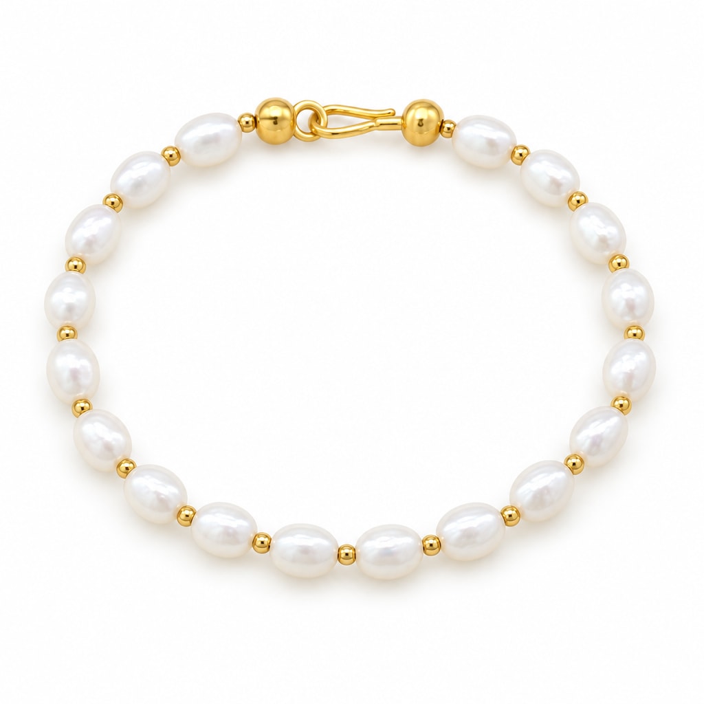 Maddalena bracelet of white rice pearls alternating with small polished metal beads, on a cream velvet tray