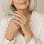 Close-up of a model's hand wearing the Maia mariner link pearl ring in gold