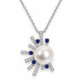 Marian pavé sunburst freshwater pearl pendant necklace with blue-tipped rays in sterling silver on white background