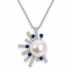 Marian pavé sunburst freshwater pearl pendant necklace with blue-tipped rays in sterling silver on white background