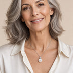 Woman wearing the Marjorie pavé ball pearl pendant necklace at the collarbone with a black strappy top