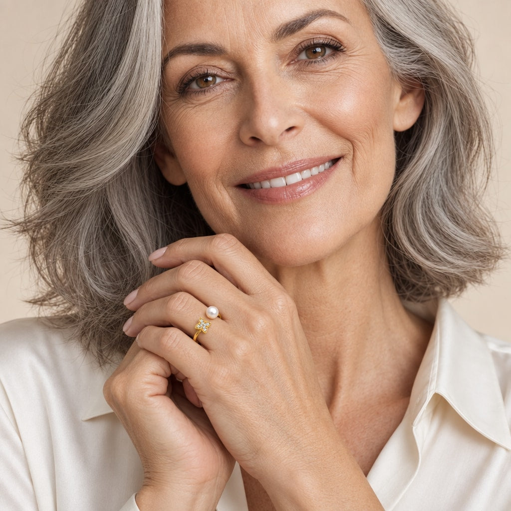 Close-up of a model's hand wearing the Marlowe pavé star and pearl open ring in gold