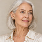 Woman in her thirties wearing the Nadine wishbone pearl stud earrings, hair up