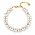 Nicoletta woven double-row white freshwater pearl bracelet with polished spacer beads, on a blue resin slab