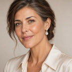 Woman in her fifties wearing the Perrine two-pearl drop earrings, hair half up