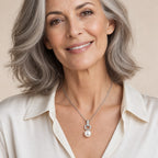 Woman wearing the Priscilla pavé ring pearl pendant necklace at the sternum with a black crew-neck top