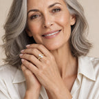 Close-up of a model's hand wearing the Tessa double pearl bypass ring in gold