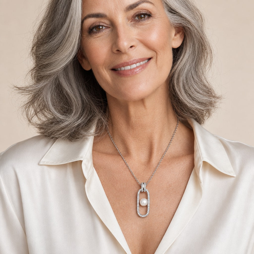 Woman wearing the Vera pavé oblong button pearl pendant necklace at the sternum with a black velvet top