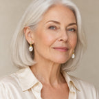 Woman in her sixties wearing the Veronique pine-cone pearl drop earrings, hair half up