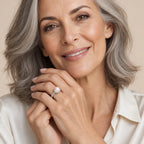 Close-up of a model's hand wearing the Wendy petal cup pavé pearl ring in sterling silver