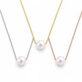 Winifred floating white pearl necklace on a fine 18K gold-plated sterling silver box chain on white background