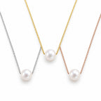 Winifred floating white pearl necklace on a fine 18K gold-plated sterling silver box chain on white background